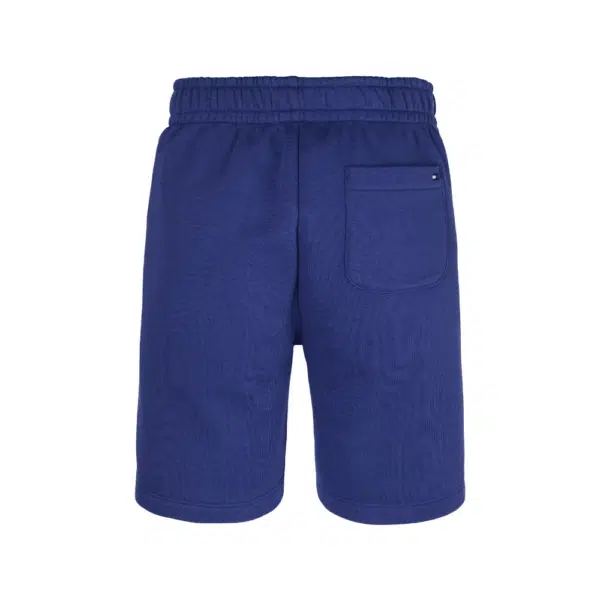 Tommy Hilfiger boys blue shorts with white circular logo front view on white background