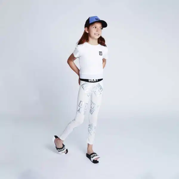 DKNY girl model in white leggings and cap