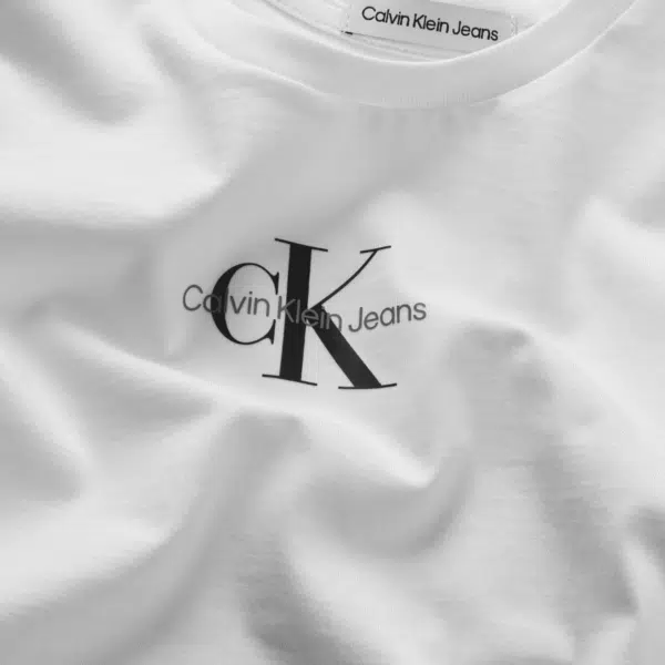 calvin klein childrens white long sleeved top with black logo on model