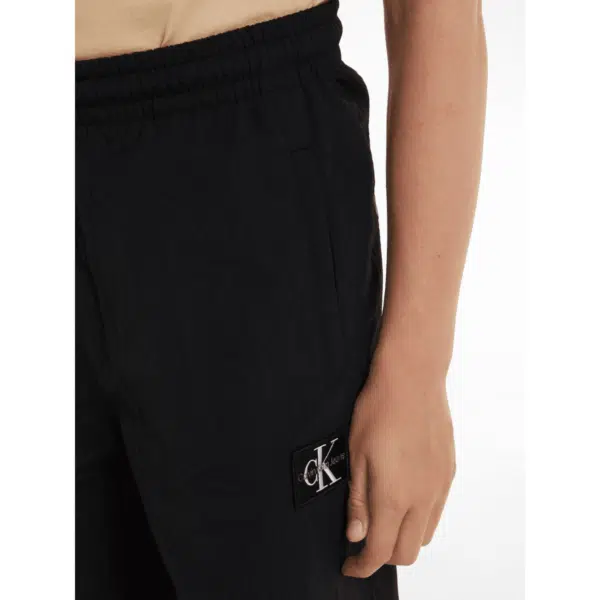 Calvin klein unisex childrens black joggers on model side view